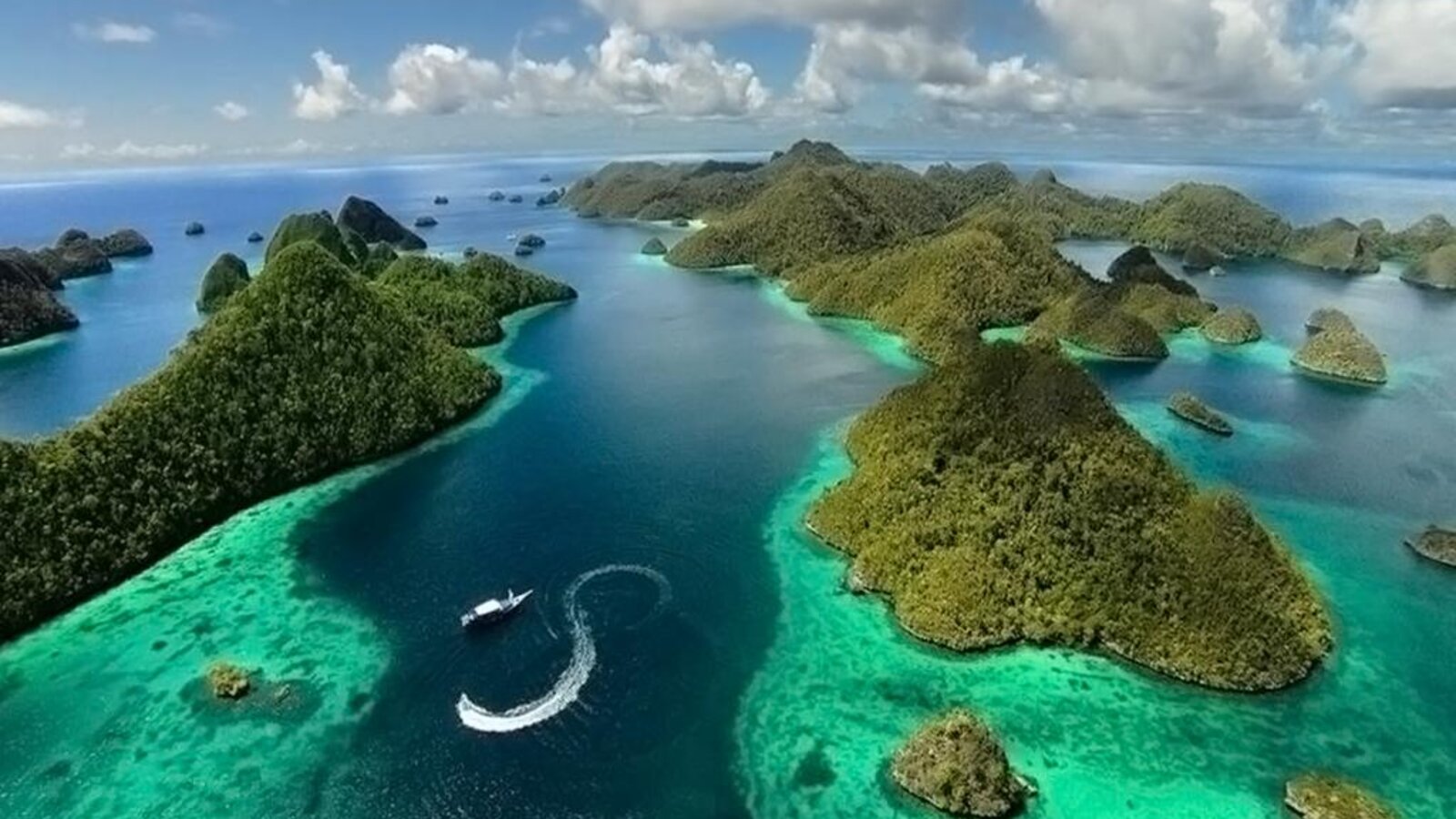 Phinisi liveaboard sailing through Raja Ampat, Indonesia